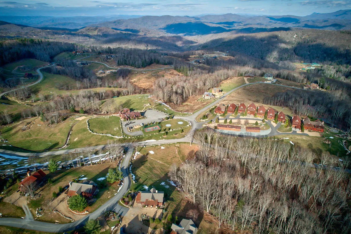 A breathtaking panoramic view of a mountain range, neighborhood layout, open green spaces, and winding roads. This image provides a sense of the broader landscape, showcasing the natural environment and the inviting exploration opportunities nearby.